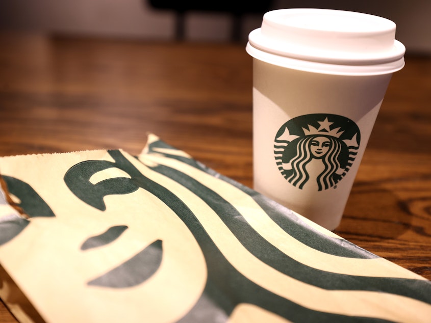 caption: Starbucks' lawyers met twice with the unionized workers of the Ithaca store to offer them the option of applying to transfer to another location after announcing the store closure. However, the company would not guarantee the workers' jobs moving forward, leaving them scrambling with little to no job security.