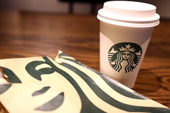 caption: Starbucks' lawyers met twice with the unionized workers of the Ithaca store to offer them the option of applying to transfer to another location after announcing the store closure. However, the company would not guarantee the workers' jobs moving forward, leaving them scrambling with little to no job security.