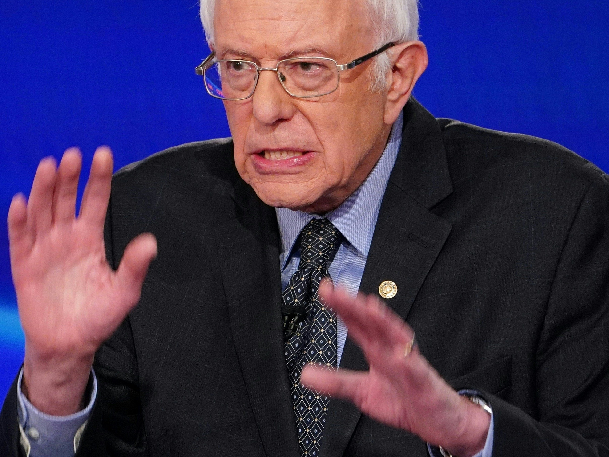caption: Senator Bernie Sanders makes a point during the 11th Democratic Party presidential debate in March.