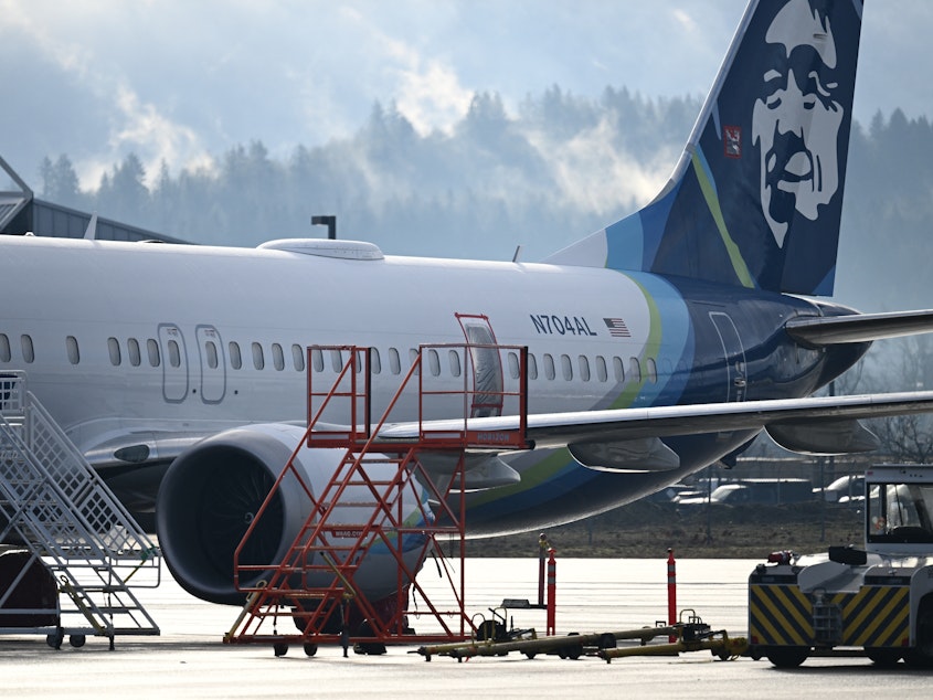 caption: Alaska Airlines N704AL, a 737 Max 9, which made an emergency landing at Portland International Airport on Jan. 5, is parked at a maintenance hanger in Portland, Ore., this week.