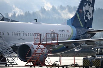 caption: Alaska Airlines N704AL, a 737 Max 9, which made an emergency landing at Portland International Airport on Jan. 5, is parked at a maintenance hanger in Portland, Ore., this week.