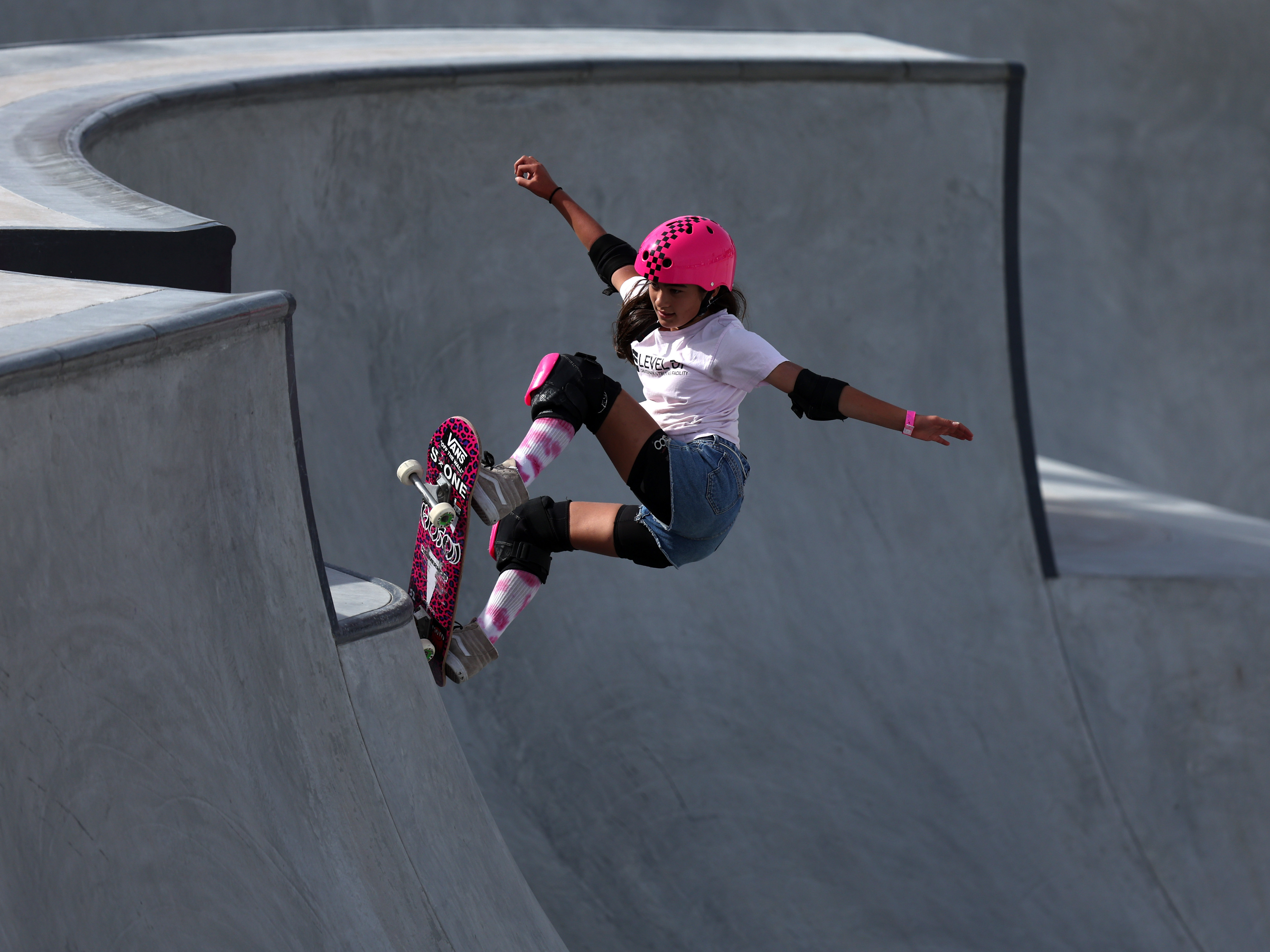 caption: Arisa Trew, the recent record breaker for the first girl to complete a 720 in competition, during the Women's Park qualifiers of the Sharjah Skateboarding Street and Park World Championships in 2023.