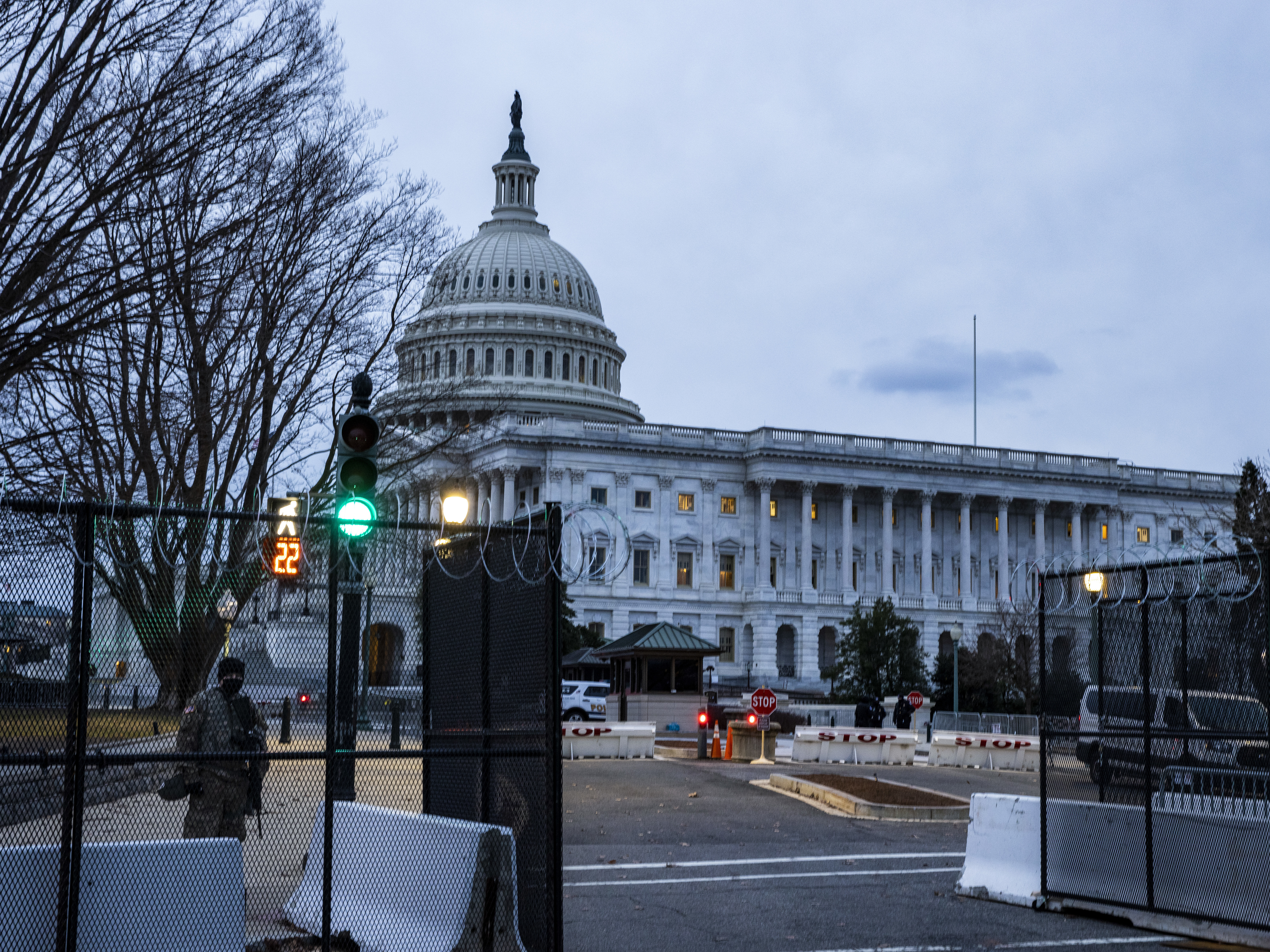 caption: Fencing and a heavy law enforcement presence are seen around the U.S. Capitol on Thursday, eight days after President Biden's inauguration.