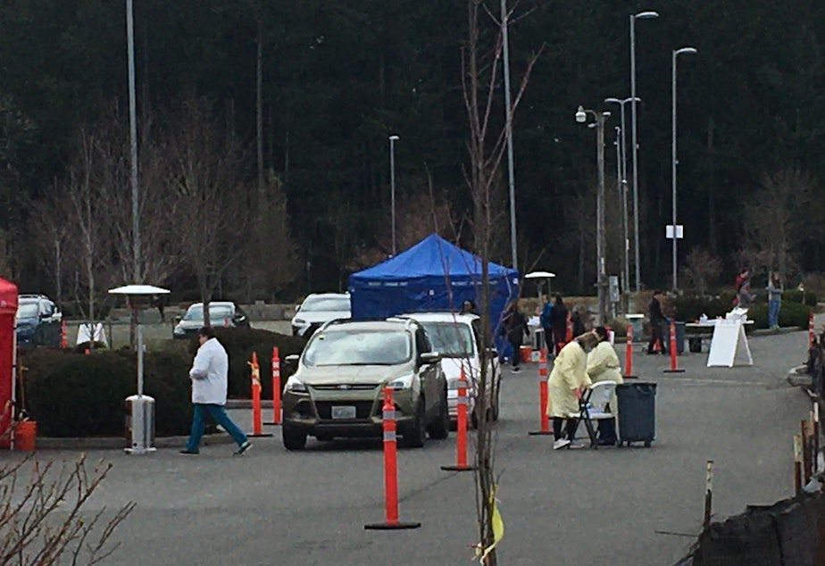 caption: On Saturday, Providence Olympia opened a drive-through COVID-19 testing site for symptomatic high-risk patients. Testing capacity in Washington has been hampered by a shortage of testing supplies and personal protective equipment.