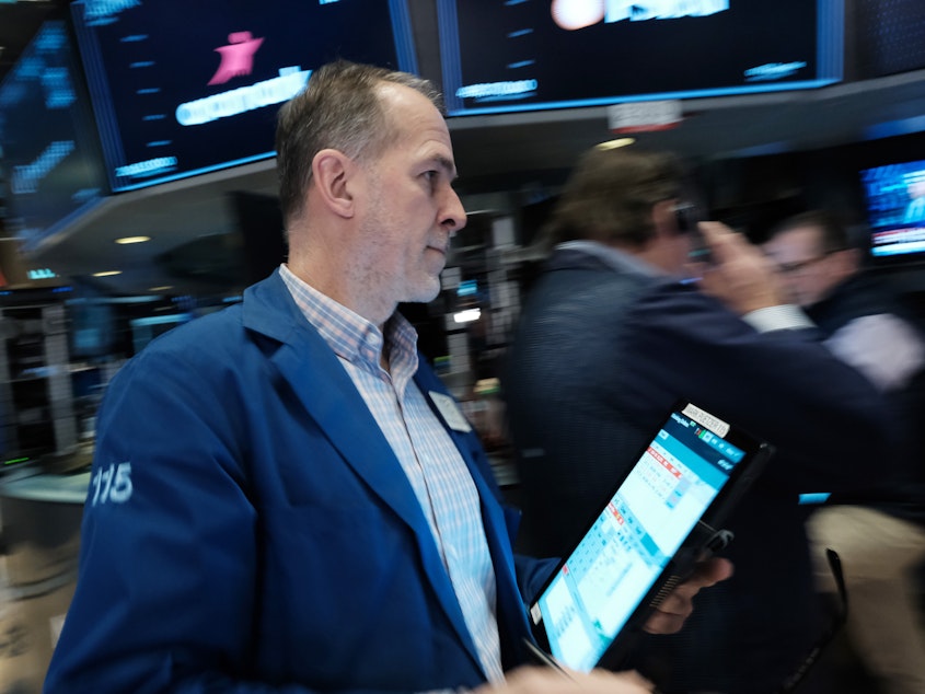 caption: Traders work on the floor during morning trading at the New York Stock Exchange (NYSE) in New York City on March 10, 2023. Bank shares slumped on Monday despite U.S. regulator action to protect deposits at Silicon Valley Bank and Signature Bank.