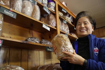 caption: Moon Bang, originally from Korea, owns the Black Diamond Bakery. She has periodically encountered racism since she bought the bakery 10 years ago.