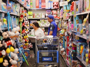 caption: People shop ahead of Black Friday at a Walmart Supercenter on Tuesday in Burbank, Calif.