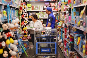 caption: People shop ahead of Black Friday at a Walmart Supercenter on Tuesday in Burbank, Calif.
