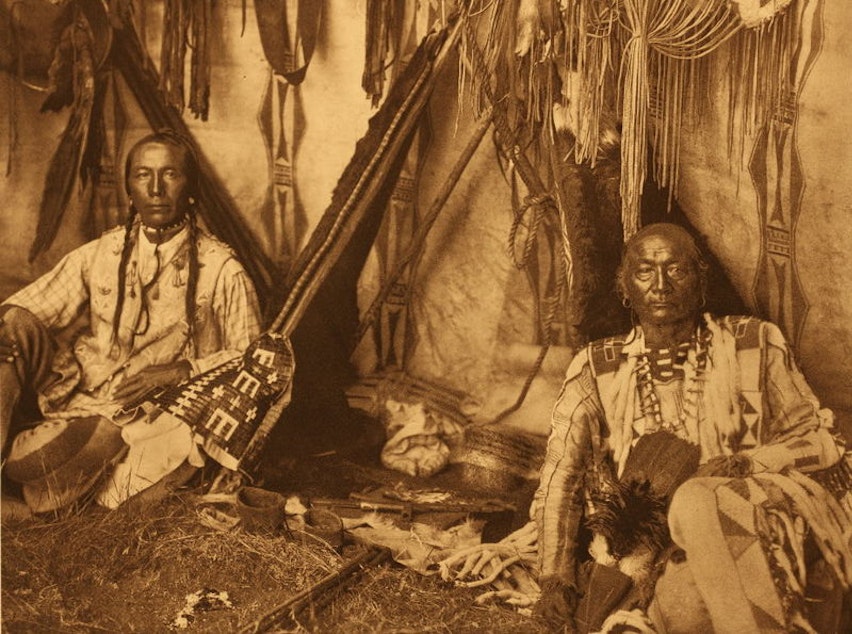 caption: Edward Curtis' "In A Pigean Lodge," 1910. This image has been criticized for retouching, implying manipulation of anthropological documents..