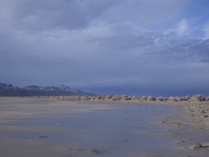 caption: Receding water in Utah's Great Salt Lake is seen on March 5. Environmentalists are suing the state to force water cutbacks to farmers to save the Great Salt Lake.