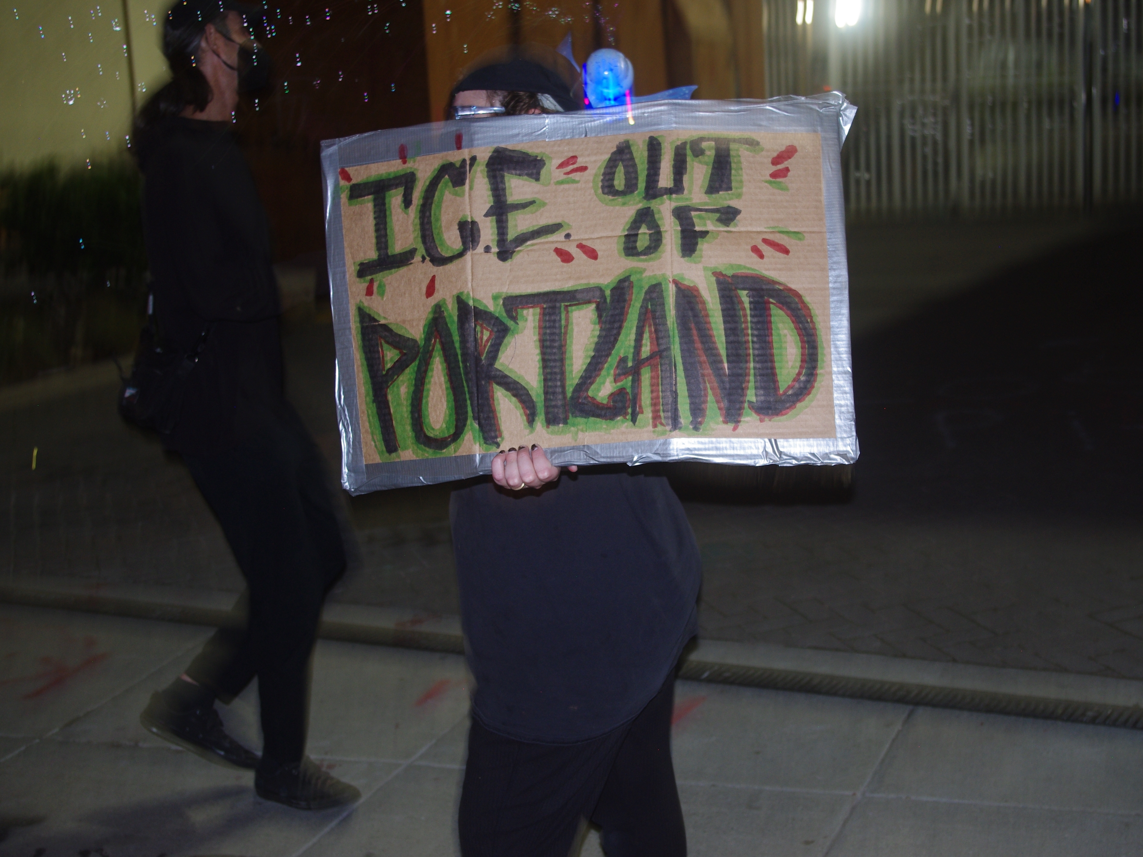 caption: Since June, there have been nightly protests outside the now-boarded-up offices of U.S. Immigration and Customs Enforcement in Portland, Ore.