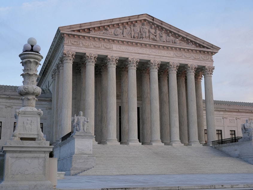 caption: The setting sun illuminates the Supreme Court building on Capitol Hill in Washington, D.C., on Jan. 10.