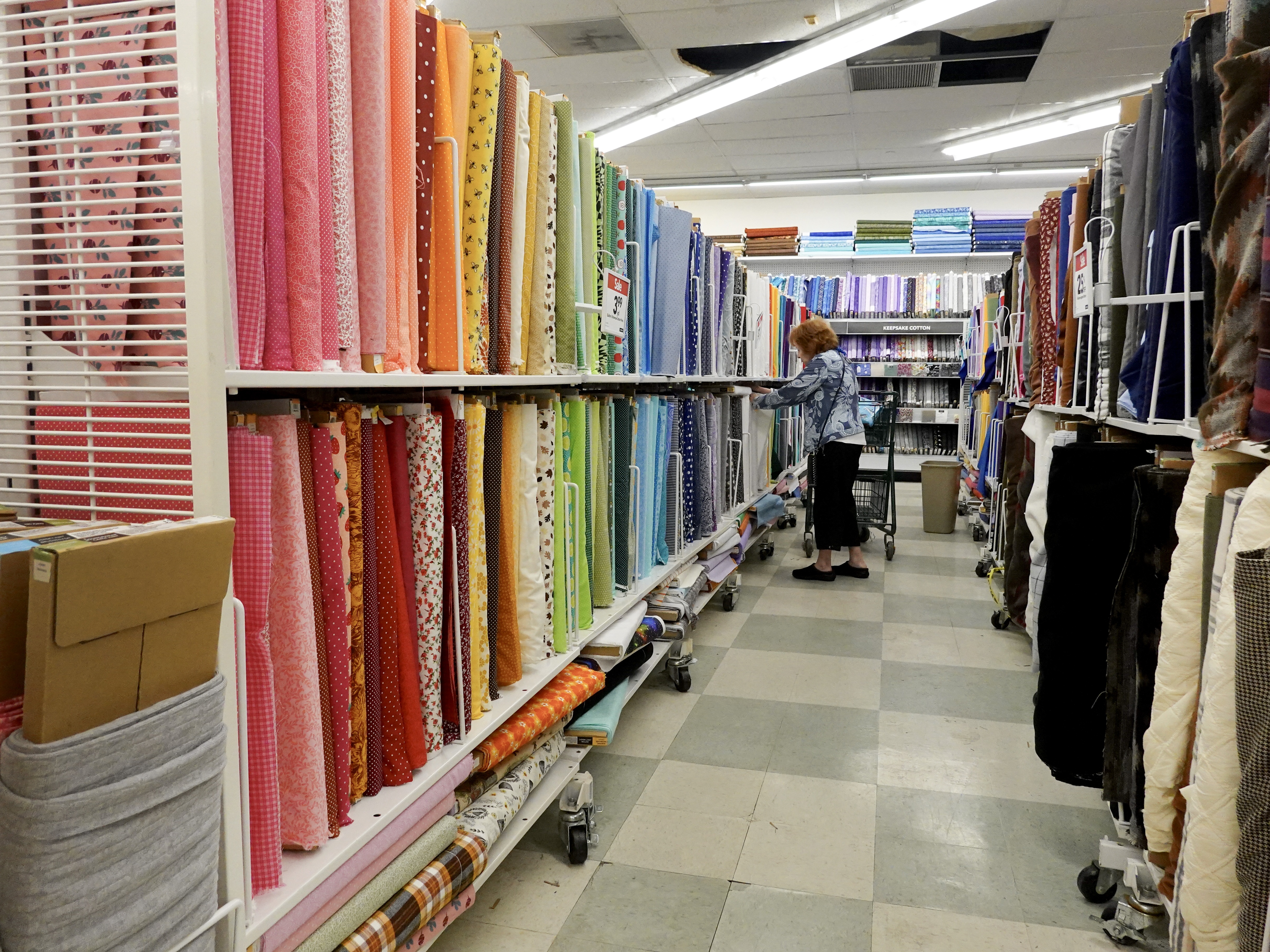 caption: A customer shops in a Joann store in Miami on Feb. 13. The retailer announced this week that it is going out of business and closing its roughly 800 stores across the U.S.