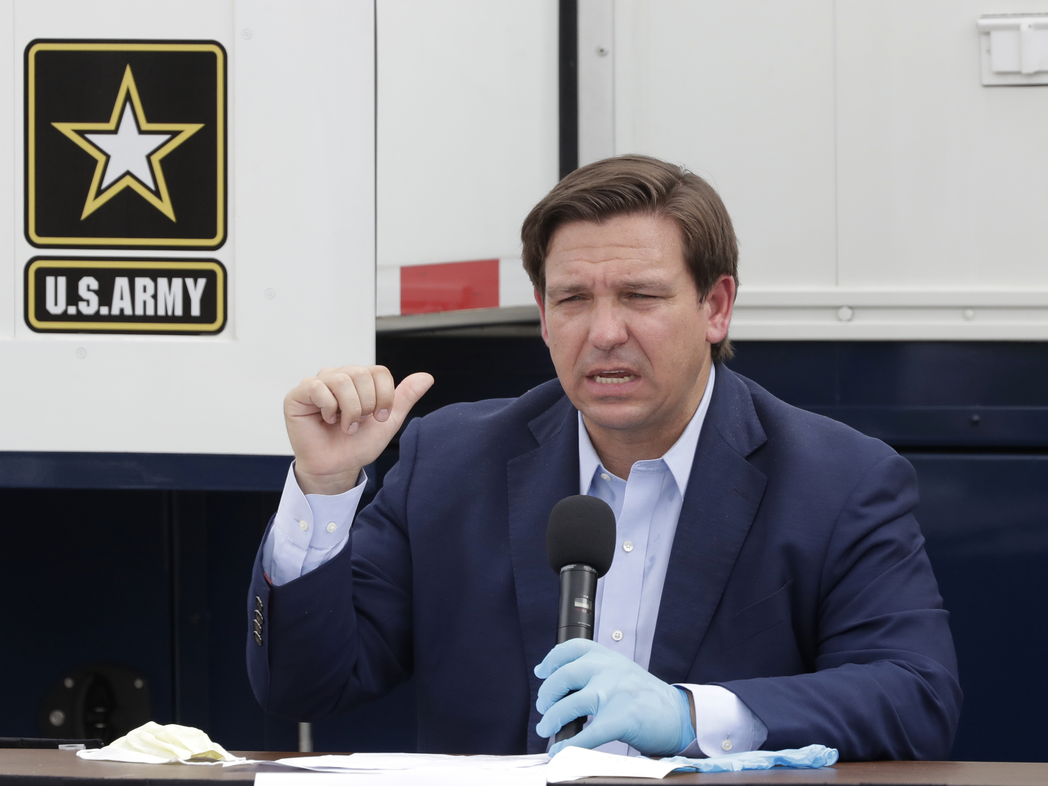 caption: Florida Gov. Ron DeSantis speaks during a news conference in front of a U.S. Army Corps of Engineers mobile command center at the Miami Beach Convention Center, last week. DeSantis says he wants to ramp up testing at the state's long-term care facilities.