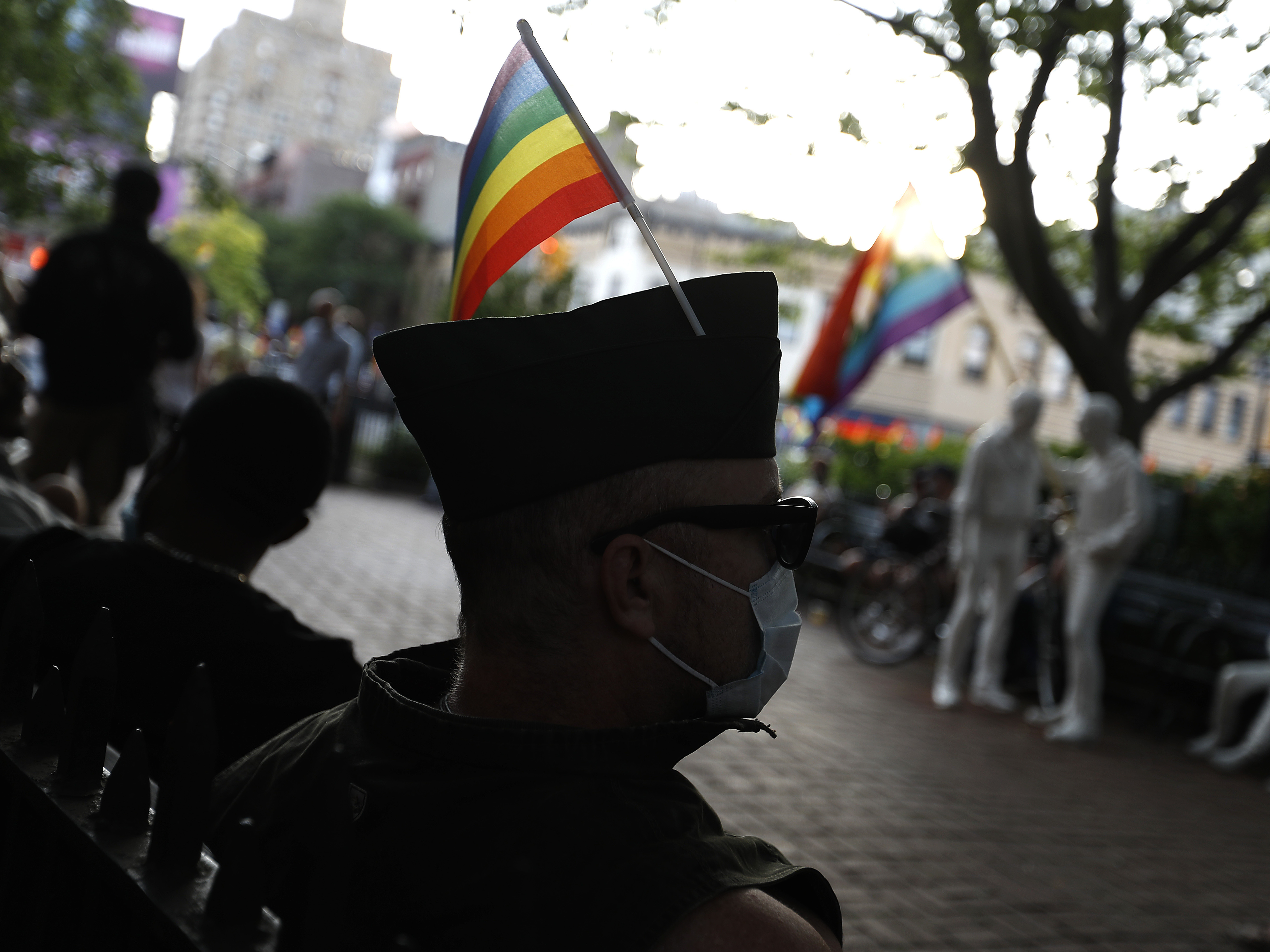 caption: People gather at the historic Stonewall Inn to celebrate the LGBTQ Supreme Court victory on June 15, 2020.