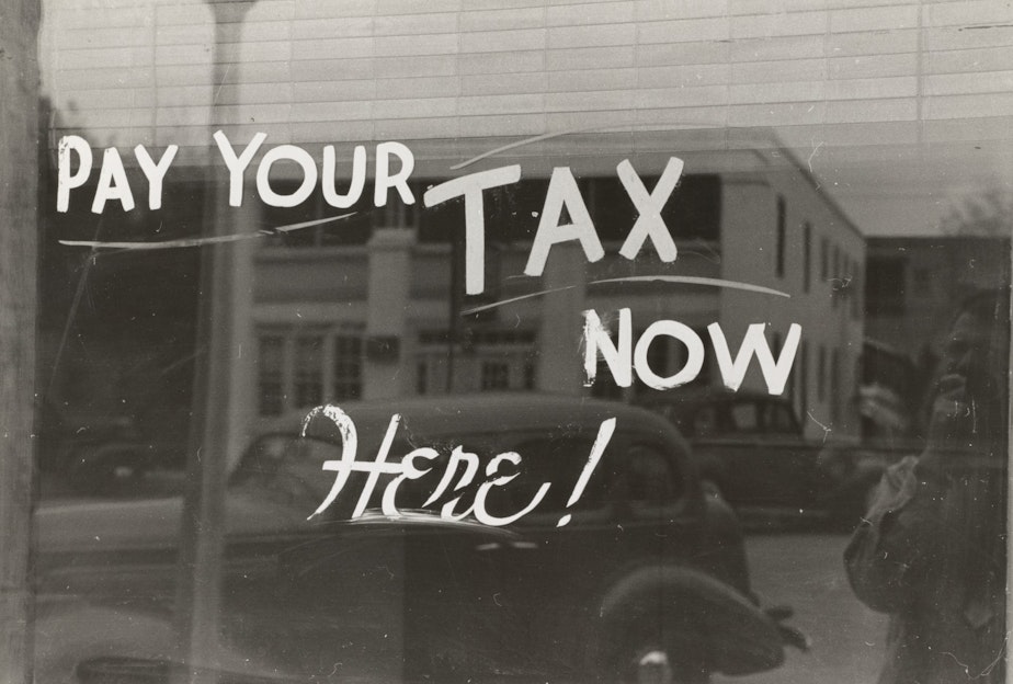 caption: "Pay your tax now, here," whispers the city of Seattle to high earners.