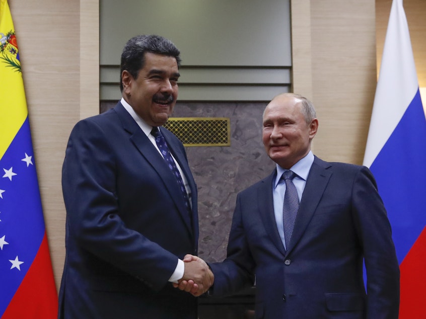 caption: Russian President Vladimir Putin shakes hands with Venezuela's Nicolás Maduro during a meeting outside Moscow on Dec. 5.