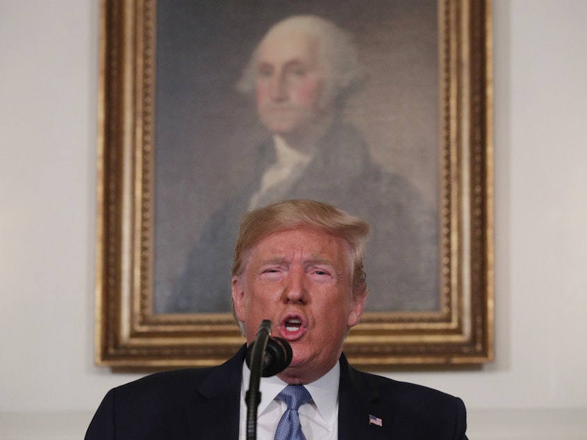 caption: President Trump speaks in the Diplomatic Reception Room of the White House on Monday regarding the mass shootings in El Paso, Texas, and Dayton, Ohio, over the weekend.