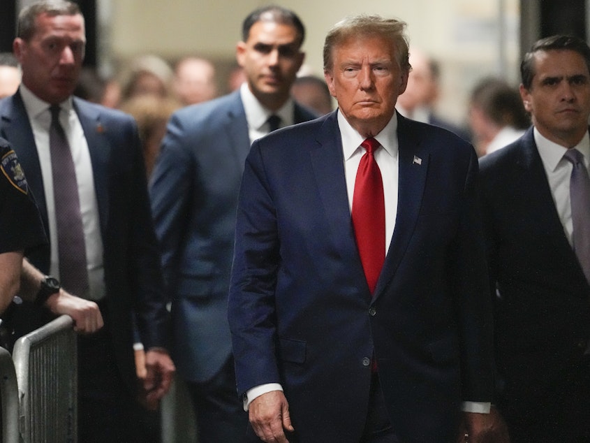 caption: Former President Donald Trump arrives at a Manhattan criminal court on Thursday in New York.