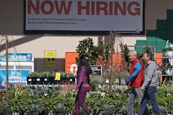 caption: Hiring accelerated in the U.S. in March, adding 303,000 jobs, according to a report from the Bureau of Labor Statistics. The unemployment rate dipped to 3.8%, staying under 4% for more than two full years. People walk past a Home Depot in San Rafael, Calif.