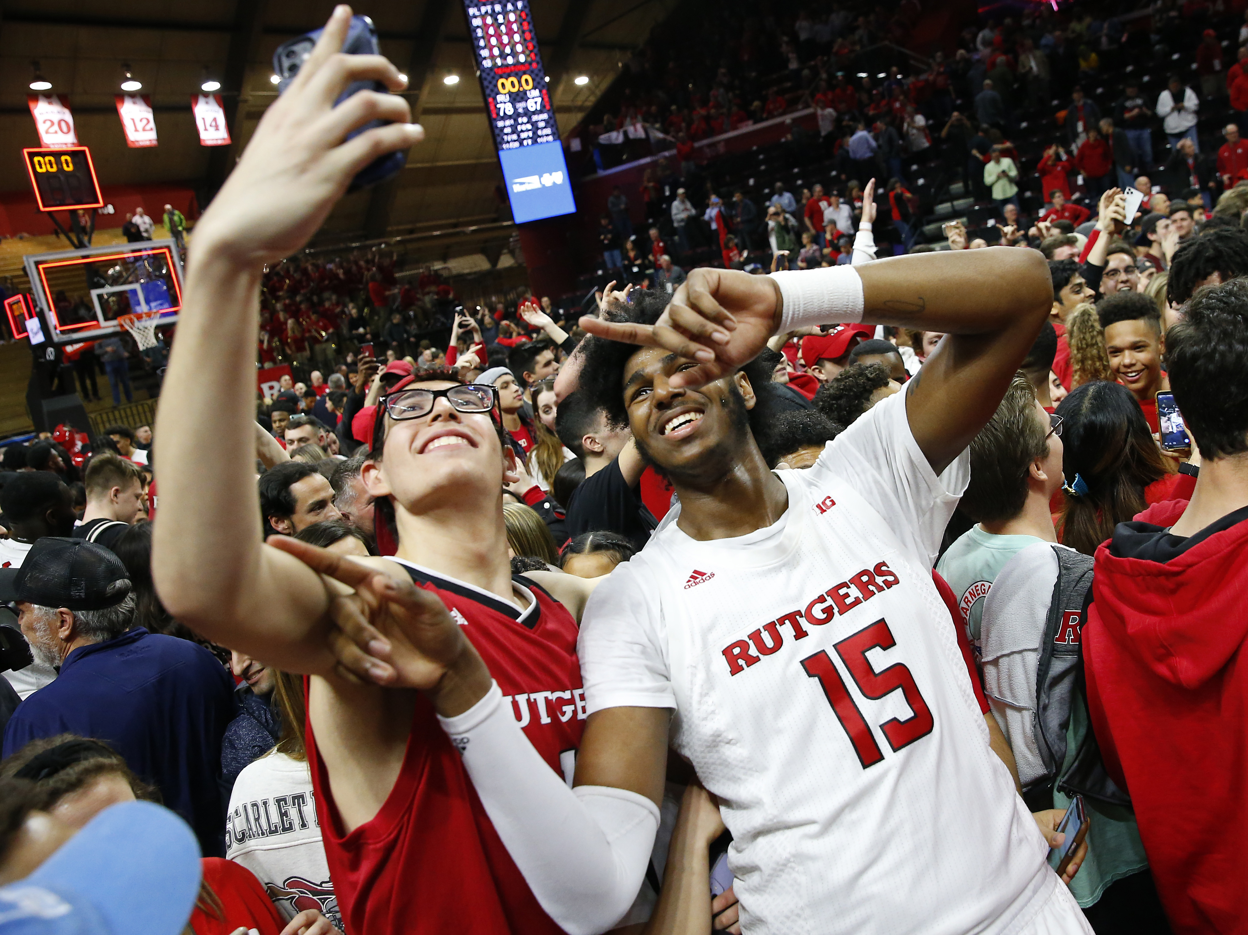 caption: The NCAA's highest governing body supports allowing student-athletes to be compensated for third-party endorsements, along with receiving money from other avenues. Here, Rutgers center Myles Johnson celebrates with fans after defeating Maryland in March, before the season was halted.