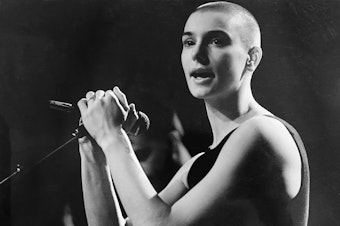 caption: Sinéad O'Connor died of natural causes according to a coroner's statement. She's pictured above performing in Vancouver, Canada in the late 1980s.