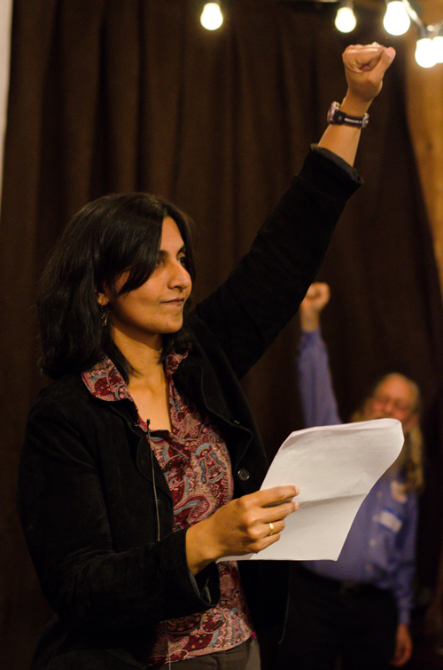 caption: Kshama Sawant pumps her fist in celebration while talking about how the election demonstrates the growing success of the socialist party in Seattle.