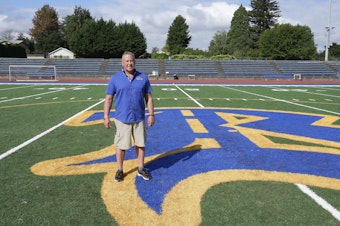 caption: Joe Kennedy, assistant coach for the Bremerton High School Knights football team, stands near the 50-yard line in Bremerton, Wash., on Wednesday, Aug. 30, 2023. Years after Kennedy left the team over objections to his post-game praying on the field, he has returned to the gridiron thanks to a Supreme Court decision, and his first game back is Friday, Sept. 1, 2023.