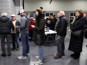 caption: Voters waiting in line at the West Des Moines caucus site on Jan. 15, 2024.