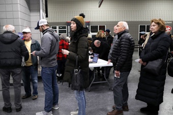 caption: Voters waiting in line at the West Des Moines caucus site on Jan. 15, 2024.