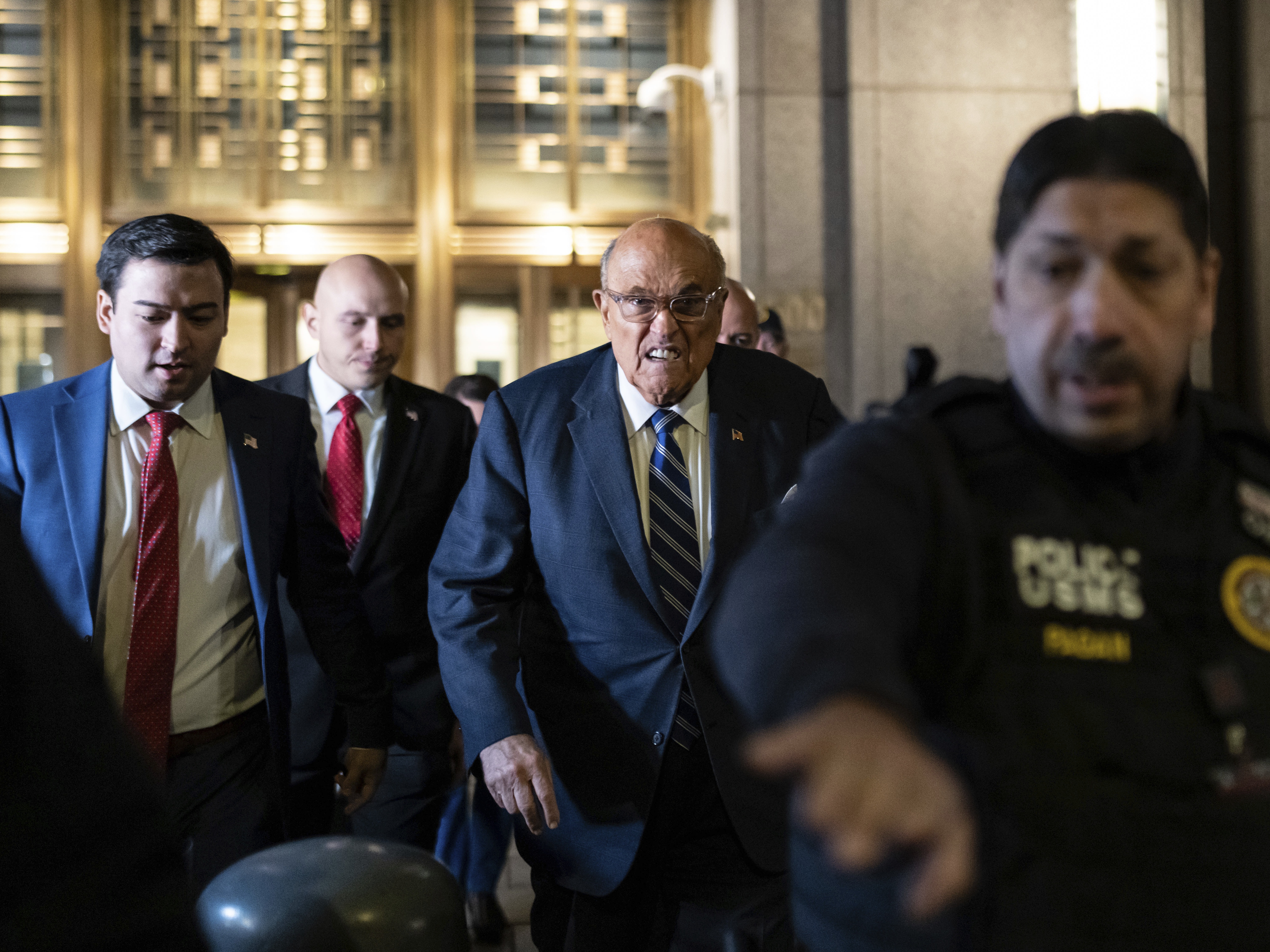caption: Rudy Giuliani leaves Manhattan federal court in New York, on Friday, Jan. 3, 2025.