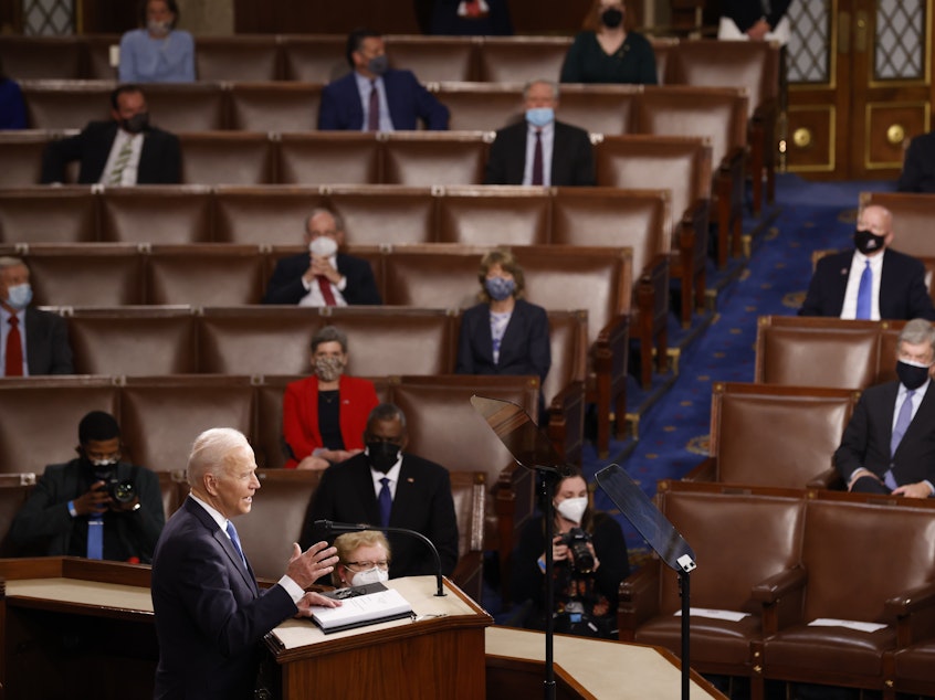caption: WASHINGTON, DC - APRIL 28: President Joe Biden addresses a Joint Session of Congress, with Speaker of the House Nancy Pelosi and Vice President Kamala Harris behind, on Capitol Hill in Washington DC.