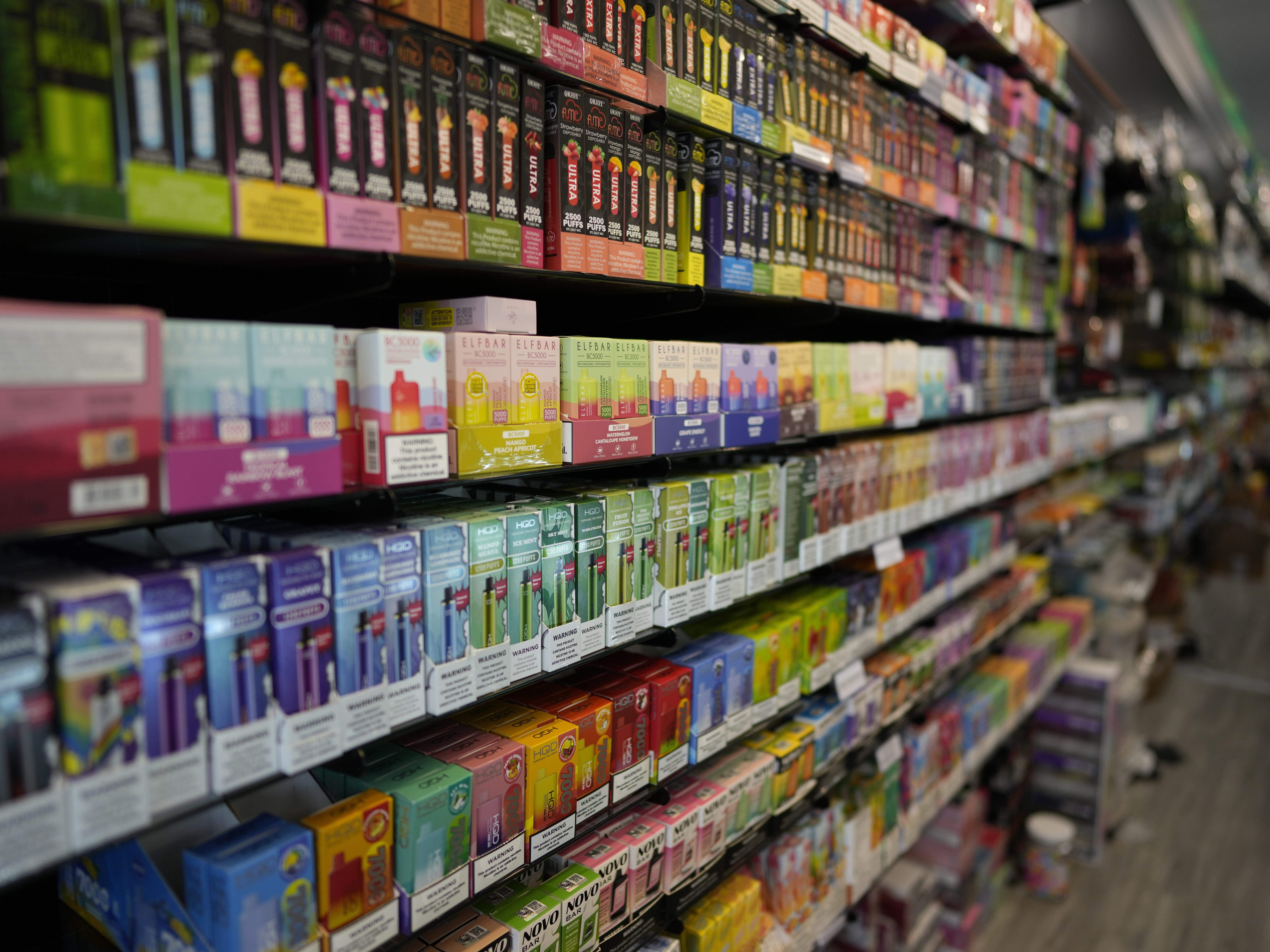 caption: Disposable vapes in many kid-friendly fruity flavors, are displayed for sale at a shop in Pinecrest, Fla., Monday, June 26, 2023. Since 2020, the number of different vaping devices for sale in the U.S. has exploded, driven by a wave of disposable models from China.
