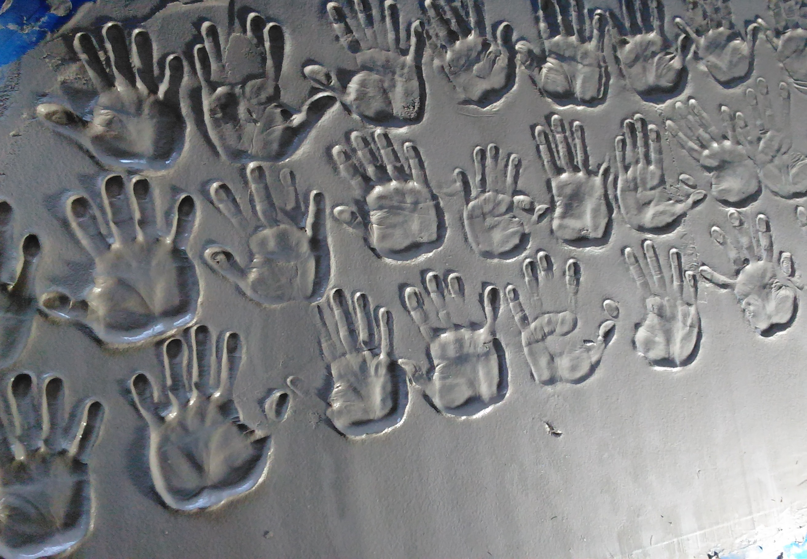 caption: Hand prints at the base of the new sign outside the Muslim Association of Puget Sound