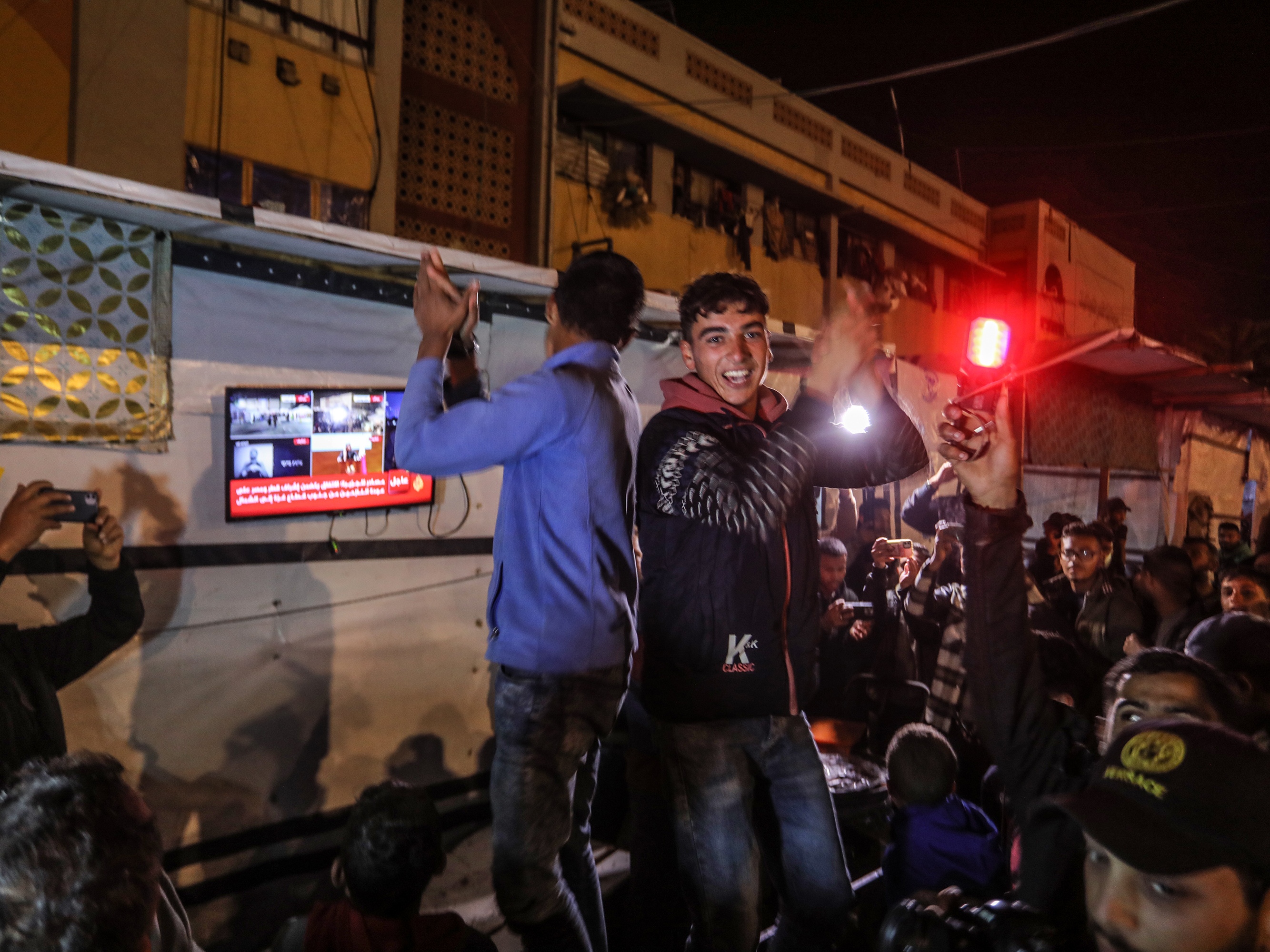 caption: Palestinians celebrate in the southern Gaza city of Khan Younis after U.S. President-elect Donald Trump's announcement of hostage deal between Israel and Hamas on Wednesday.