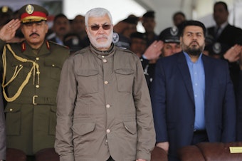 caption: In this 2016 file photo, Abu Mahdi al-Muhandis, center, attends a ceremony marking Police Day in Baghdad, Iraq. Muhandis was killed in a drone strike early Friday.