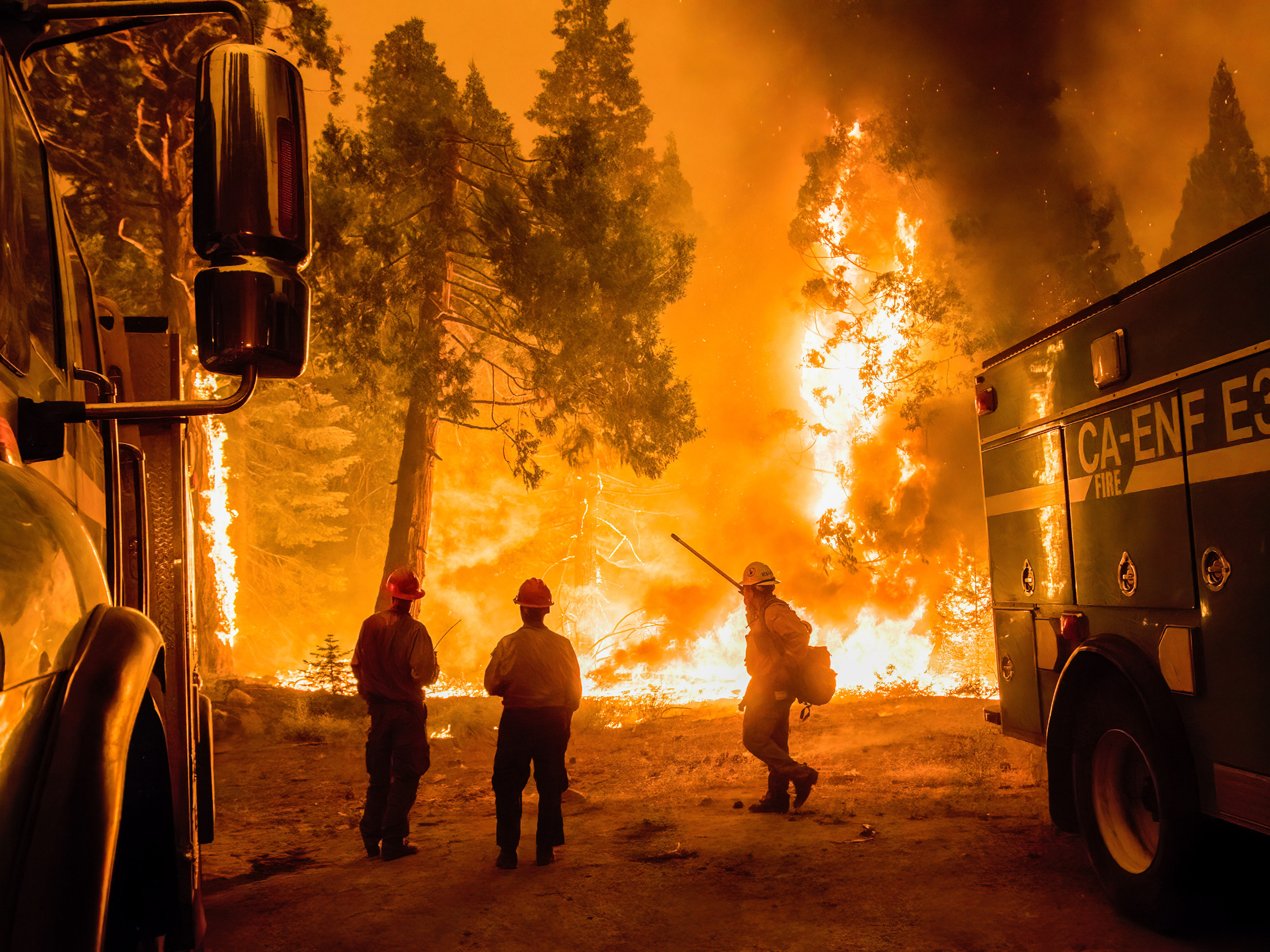 caption: Crews set a backfire in an effort to gain control of the massive Caldor fire near the Tahoe basin in California on Aug. 26.