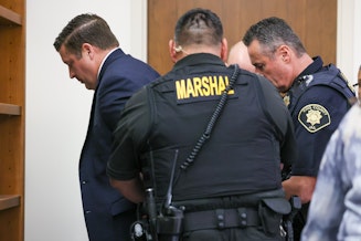 caption: Auburn police Officer Jeffrey Nelson is taken into custody after a jury in Kent convicted him Thursday of second-degree murder and first-degree assault in the 2019 shooting death of Jesse Sarey.  