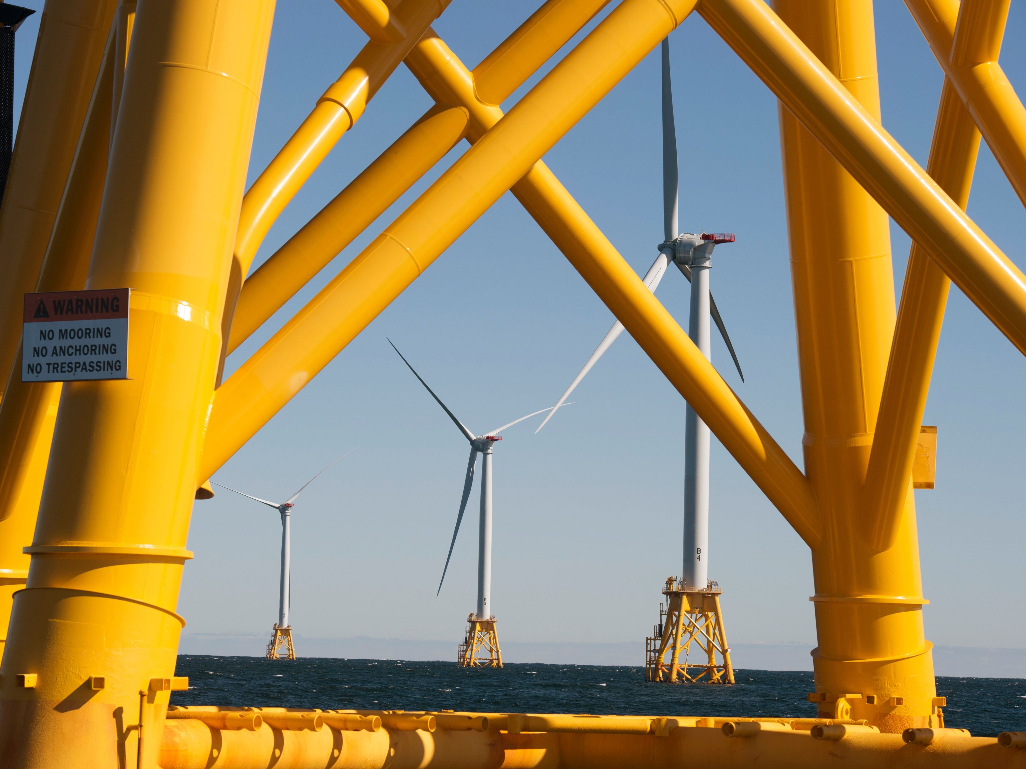 caption: Wind turbines off the coast of Rhode Island. Supporters say offshore wind projects are a valuable resource for meeting rising power demand and ensuring electric reliability.