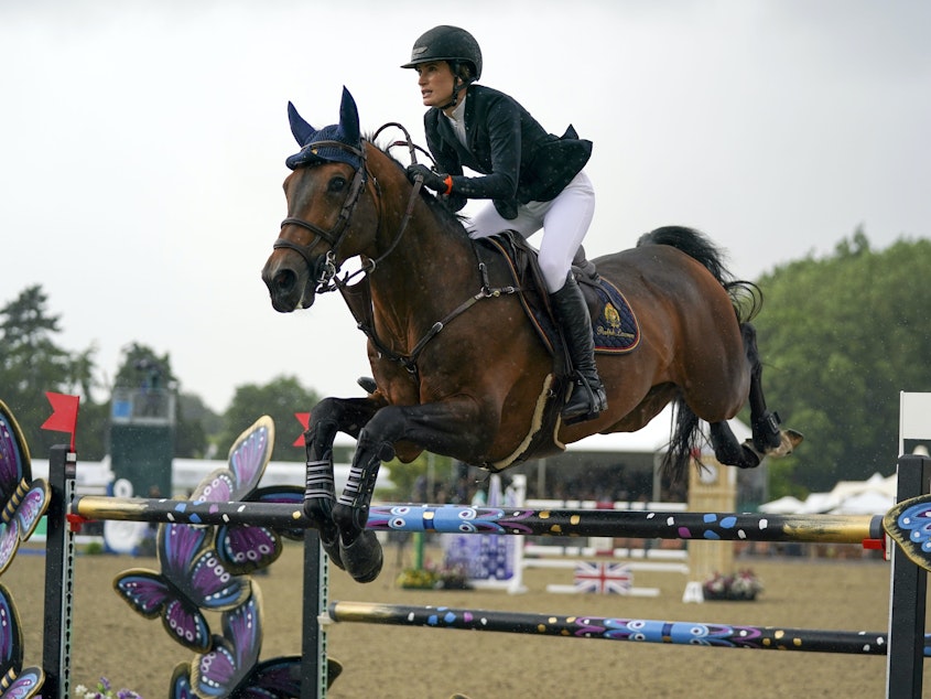 caption: Jessica Springsteen rides Don Juan van de Donkhoeve while competing Sunday in the Rolex Grand Prix at the Royal Windsor Horse Show in England.