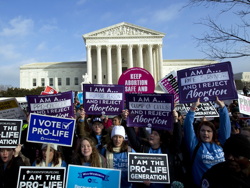 caption: Anti-abortion activists protest outside of the U.S. Supreme Court. The Supreme Court has rejected laws that tie abortion rights to a specific week in a woman's pregnancy, but this is the first time a judge has struck down the 1973 law.