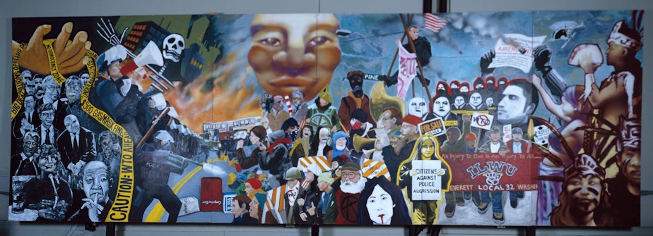 caption: WTO mural created by Lauren Holloway, Erin Koch, Yoona Lee, Cause B, and Verse Omega.