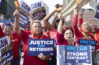 caption: United Auto Workers members attend a solidarity rally as the UAW strikes the Big Three automakers on Sept. 15 in Detroit.