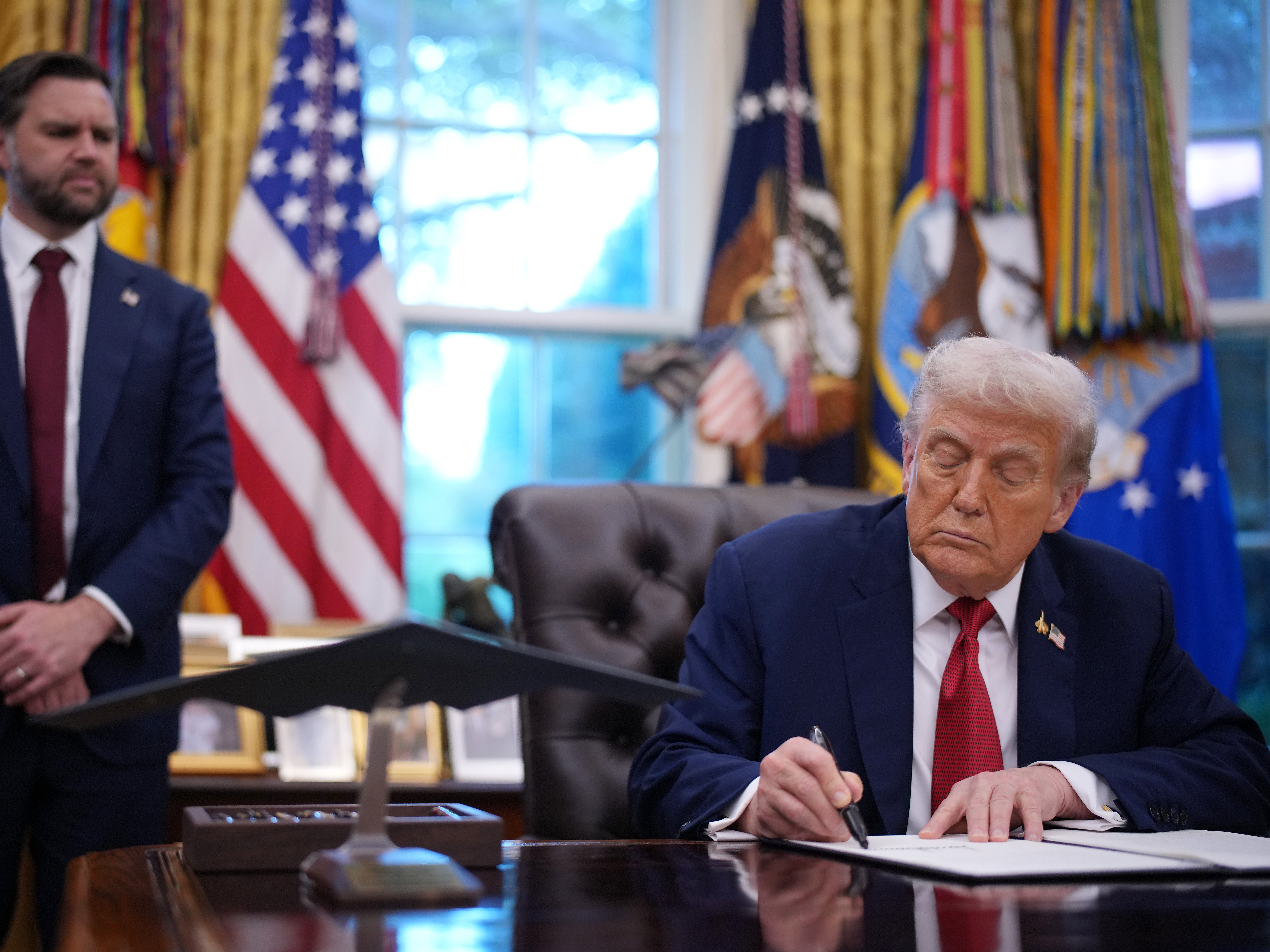 caption: Vice President Vance looks on as President Trump signs an executive order in the Oval Office on Thursday in Washington, D.C. Trump signed an order approving a partial sale of TikTok's U.S. operations, following a 2024 law requiring parent company ByteDance to divest or face a ban.