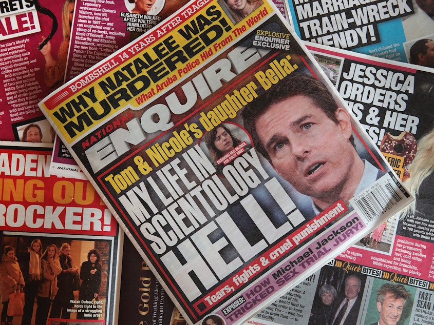 caption: American Media Inc., parent company of the <em>National Enquirer</em>, struck a deal to sell the tabloid and two other publications.