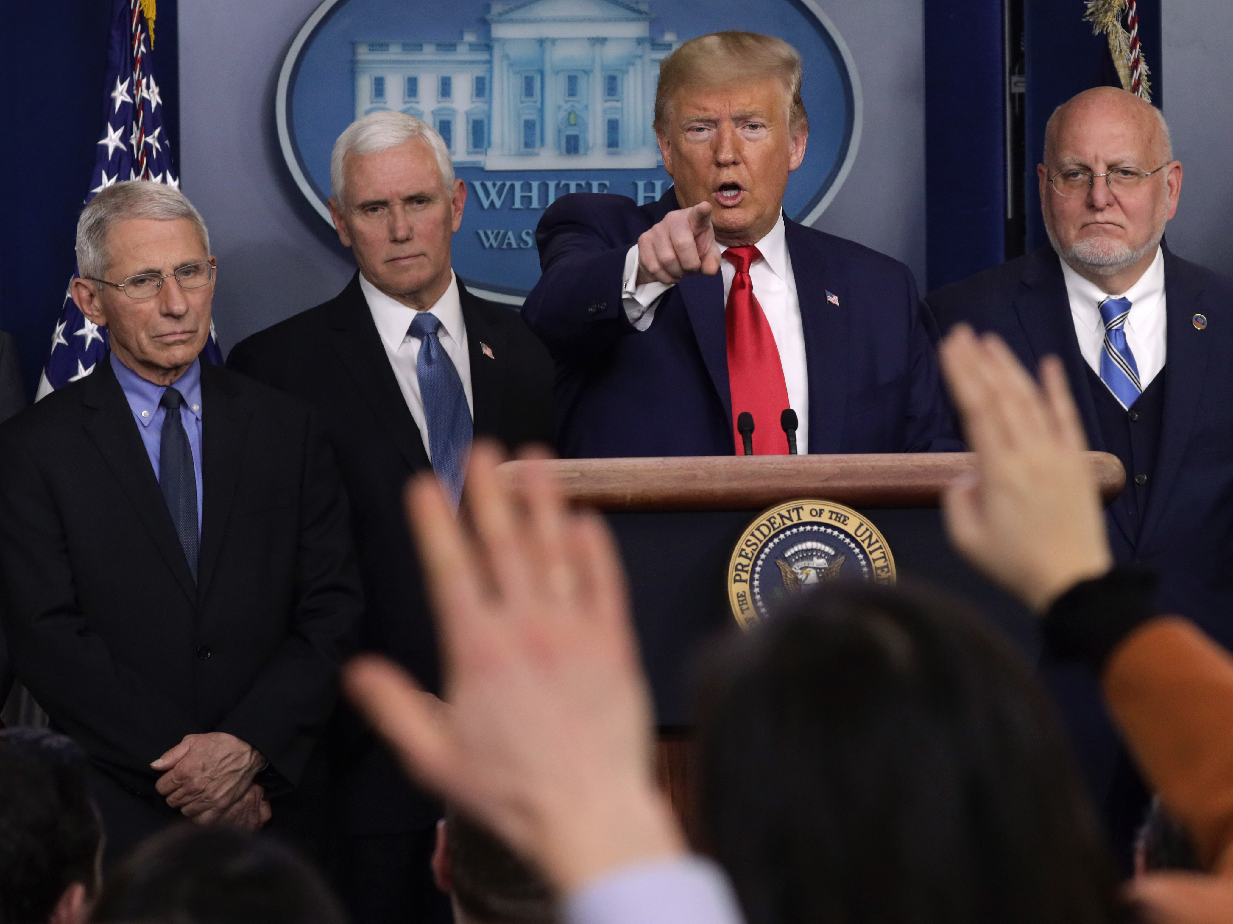 caption: President Trump takes questions at a press conference with, from left, National Institute for Allergy and Infectious Diseases Director Anthony Fauci, Vice President Mike Pence and Centers for Disease Control and Prevention Director Robert Redfield.