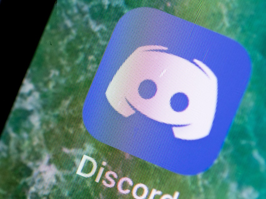 caption: Group-chat app Discord announced on Monday that in the second half of 2020, it took down more than 2,000 communities dedicated to extremist causes, of which more than 300 focused on the baseless conspiracy theory QAnon.