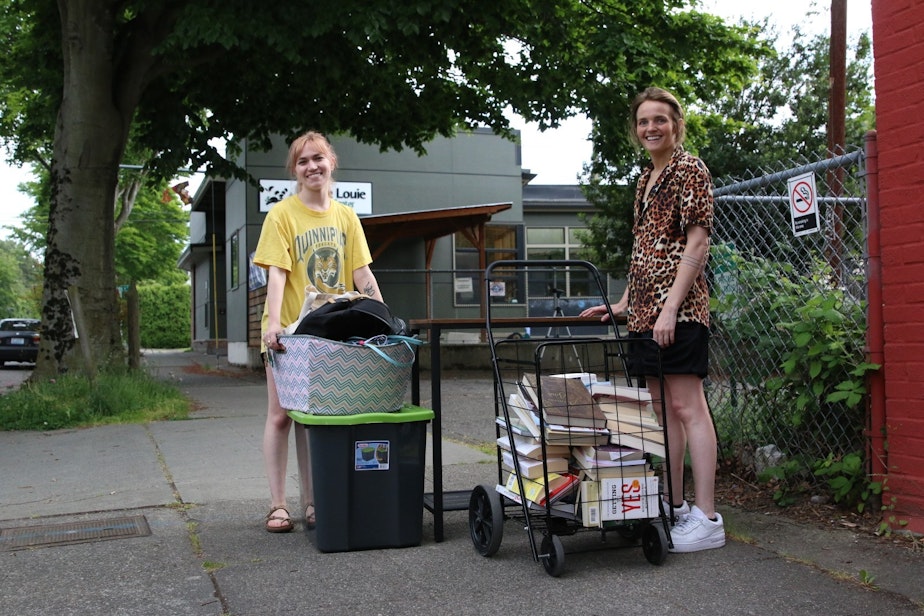 caption: Kate Huntington, left, on moving day. Huntington had lived in Portland, Oregon, but was promoted. She moved to Seattle during the pandemic.