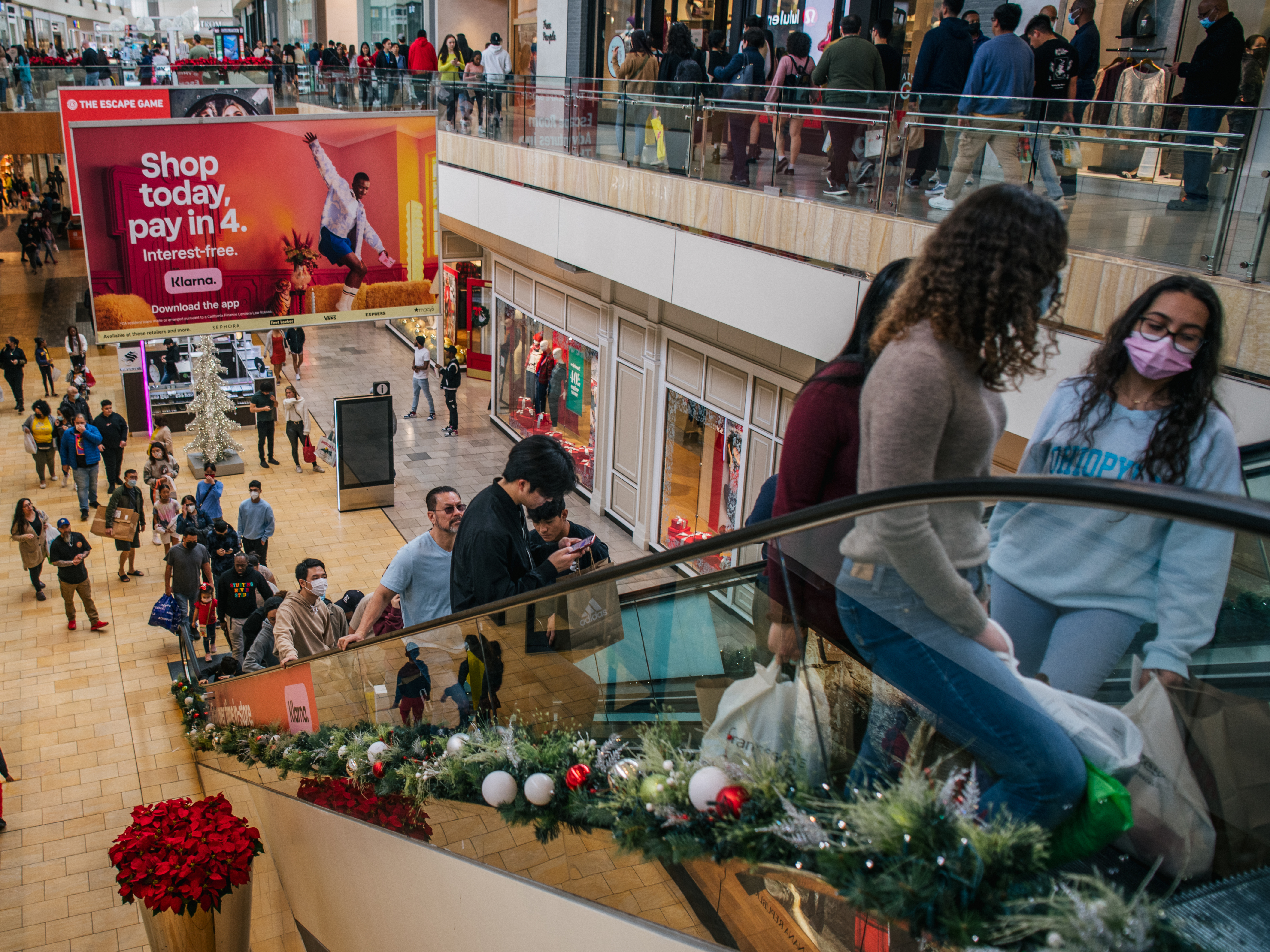 caption: People shop in The Galleria mall during Black Friday on November 26, 2021 in Houston, Texas.