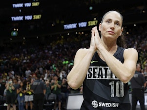 caption: Sue Bird reacts after Tuesday's game, the last of her career, at the 2022 WNBA Playoffs semifinals in Seattle, Wash.